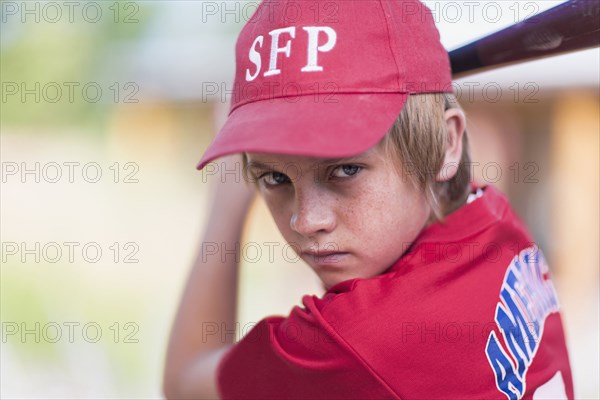 Caucasian boy playing baseball outdoors