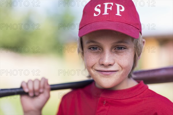 Caucasian boy playing baseball outdoors