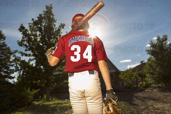 Caucasian boy playing baseball outdoors