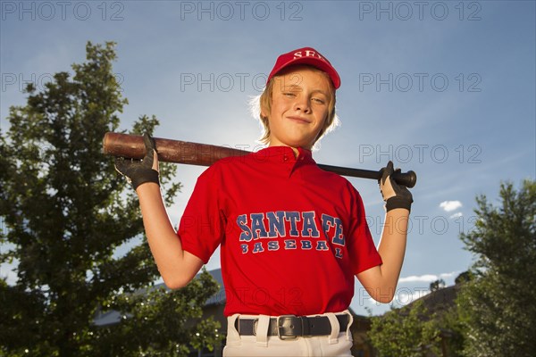 Caucasian boy playing baseball outdoors