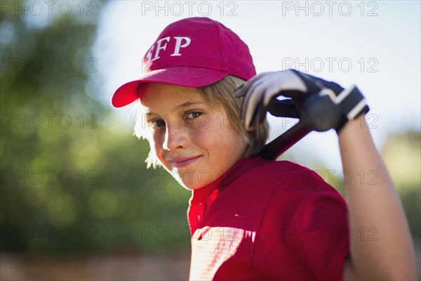 Caucasian boy playing baseball outdoors