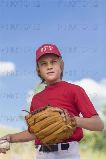 Caucasian boy playing baseball outdoors