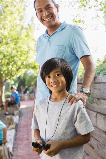 Father and son smiling outdoors