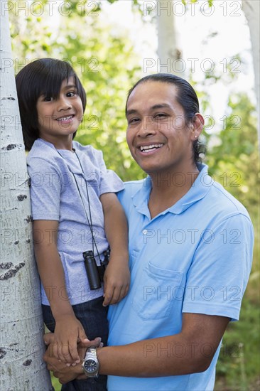 Father holding son outdoors