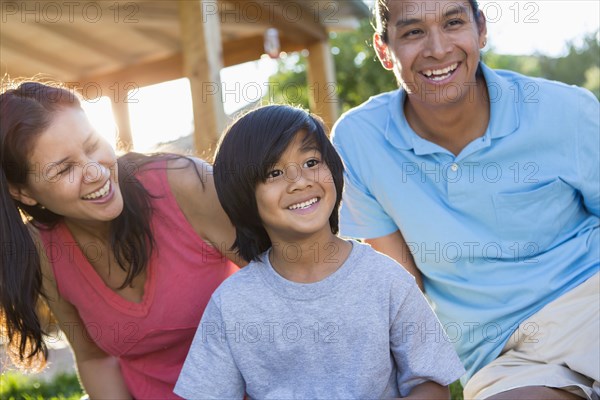 Family smiling outdoors