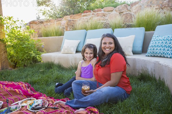 Mother and daughter eating outdoors