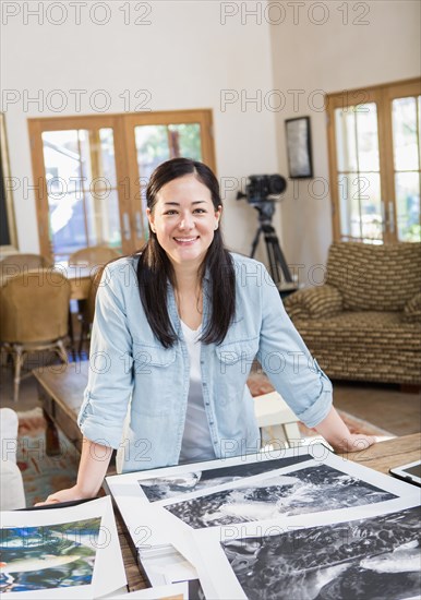 Mixed race photographer examining photographs