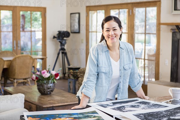 Mixed race photographer examining photographs