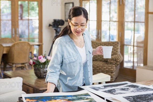 Mixed race photographer examining photographs