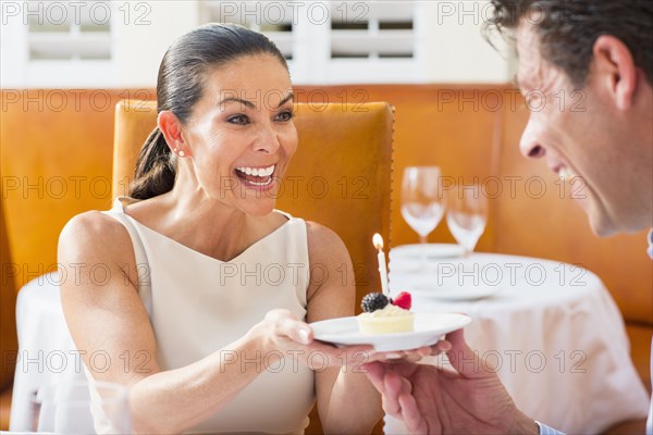 Couple celebrating birthday at restaurant