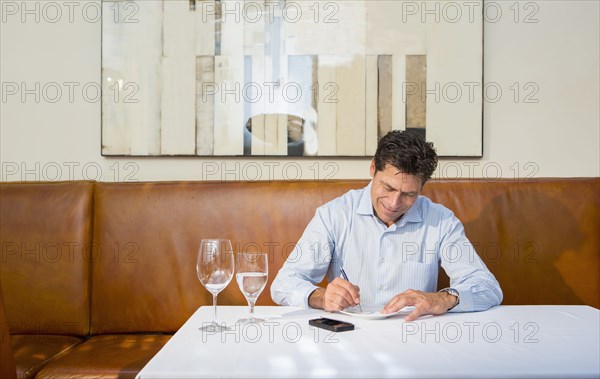 Caucasian businessman working at restaurant