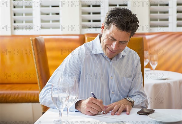 Caucasian businessman working in restaurant