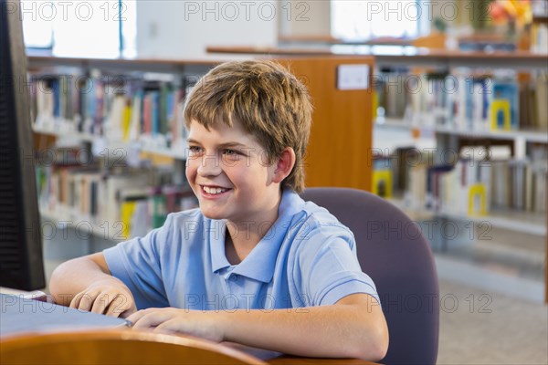 Student working at computer in library