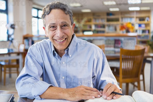 Senior man working in library