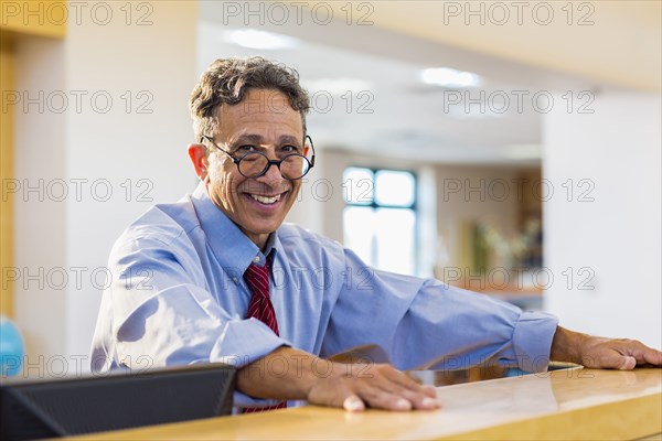 Senior man smiling in library