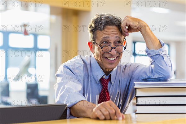 Senior man smiling in library