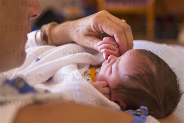 Caucasian mother holding newborn baby