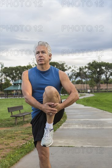 Hispanic man stretching outdoors