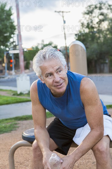 Hispanic man resting in park