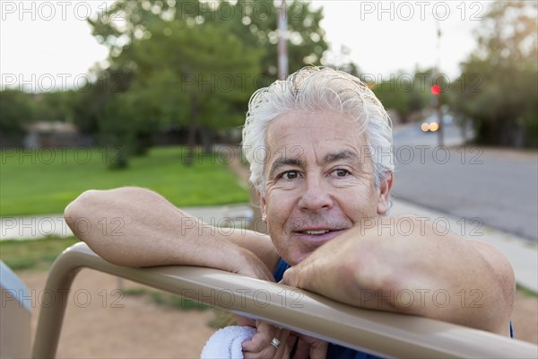 Older Hispanic man exercising in park