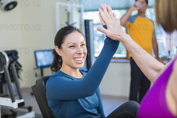 Women high-fiving in gym