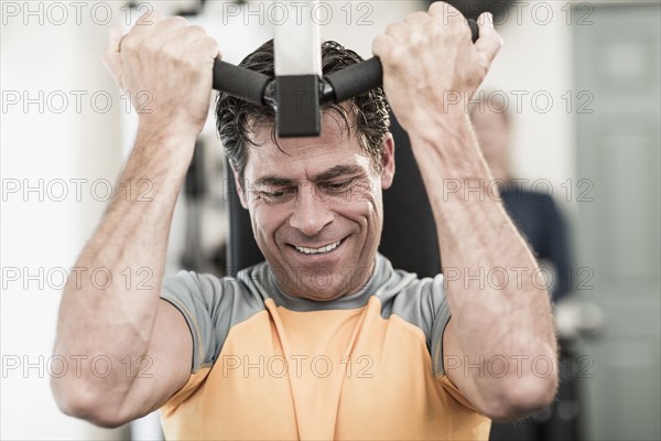 Caucasian man exercising in gym