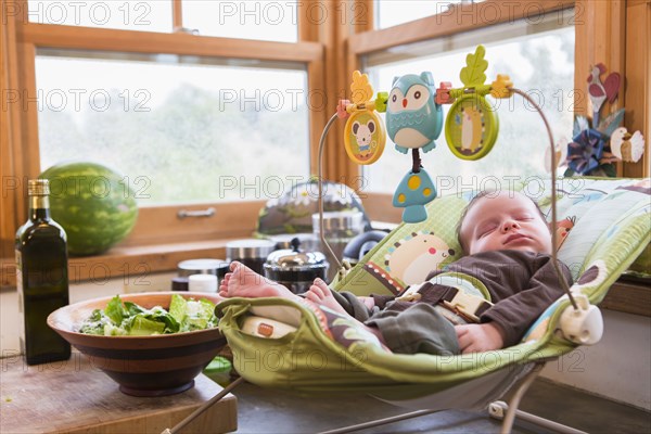 Caucasian newborn sleeping in baby seat