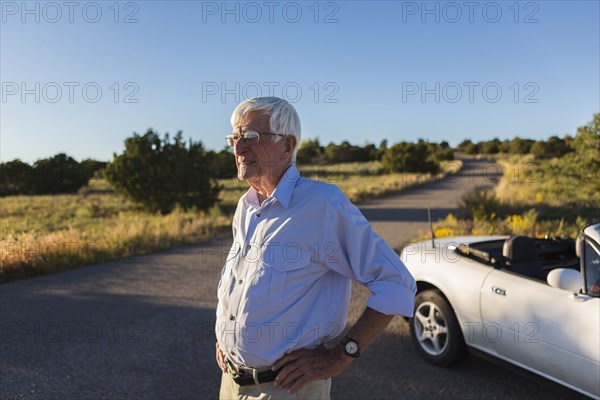 Senior Caucasian man standing on rural road