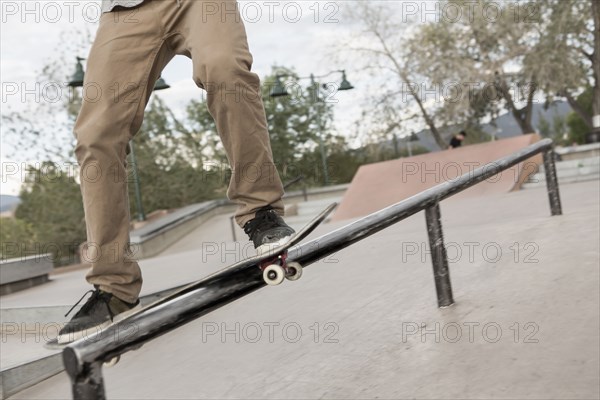 Mixed race boy skateboarding in park