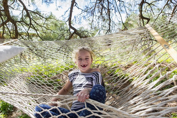 Caucasian girl laughing in hammock