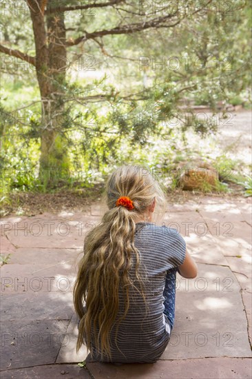 Caucasian girl sitting outdoors