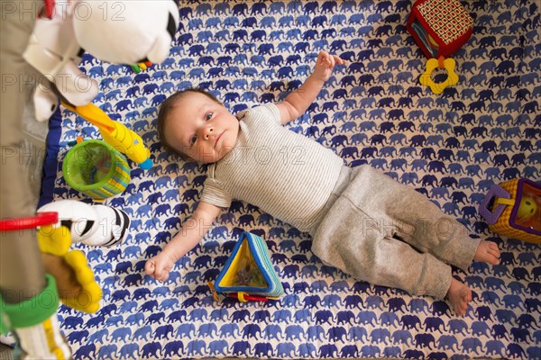 Caucasian newborn laying in crib