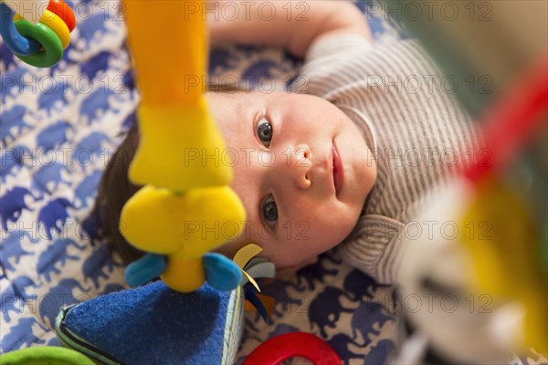 Caucasian newborn laying in crib