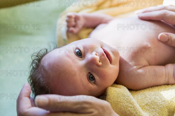 Caucasian newborn laying on towel