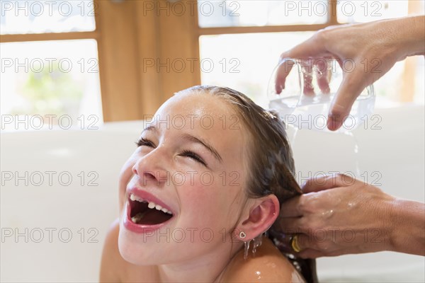 Mother washing daughter's hair