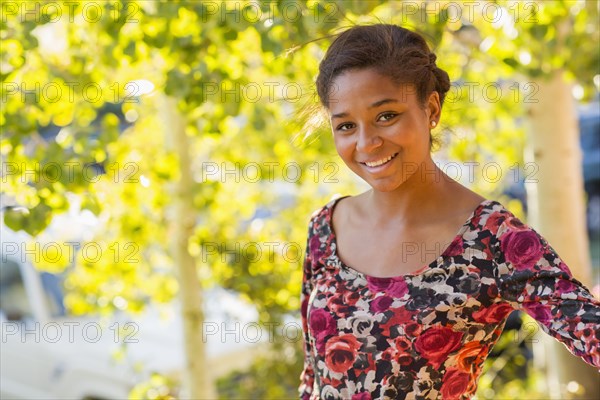 Mixed race teenage girl smiling outdoors