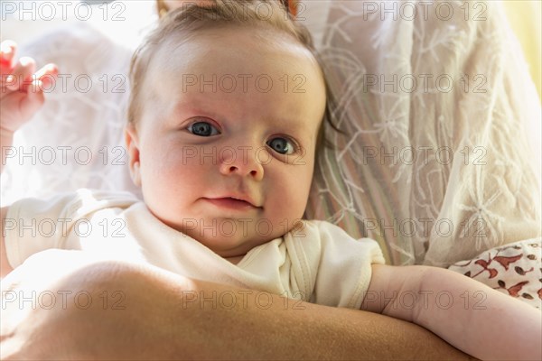 Mother holding smiling baby