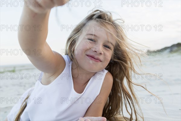 Girl playing in sand on beach