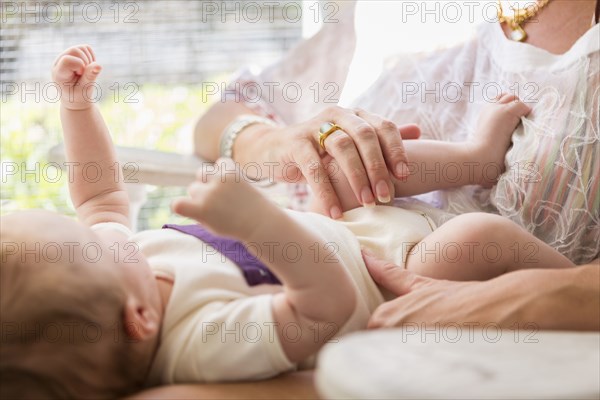 Caucasian mother playing with baby boy