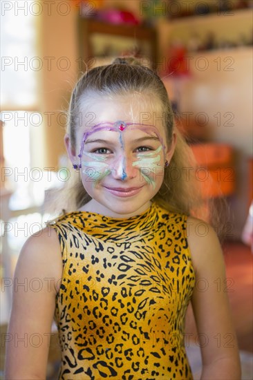 Caucasian girl wearing face paint and costume