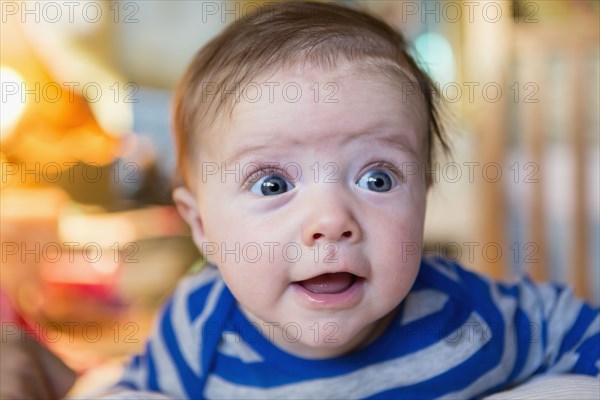 Close up of wide-eyed Caucasian baby boy