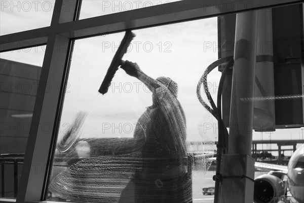 Window washer cleaning window