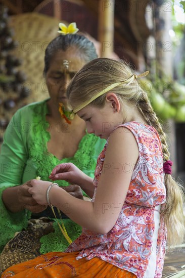 Girl learning Balinese weaving