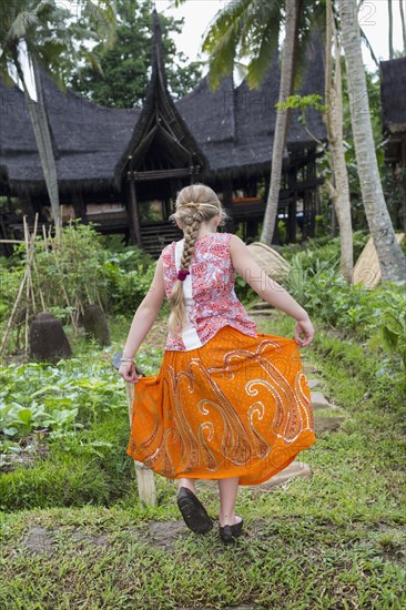 Caucasian girl walking in garden