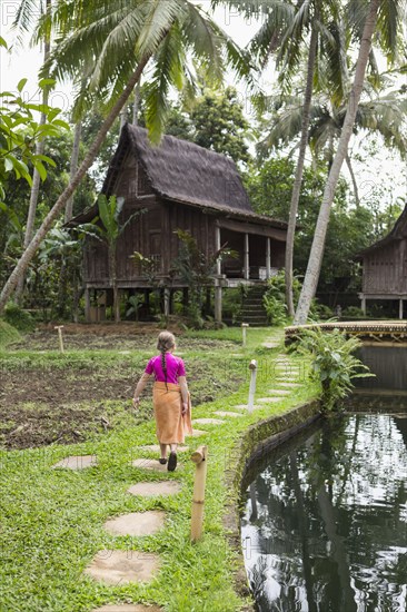 Caucasian girl walking on path in garden