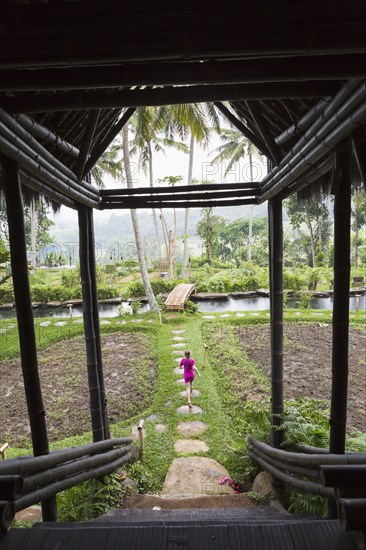 Caucasian girl walking on path in garden