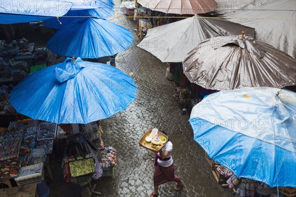 Rain falling over tarps and awnings of market stalls