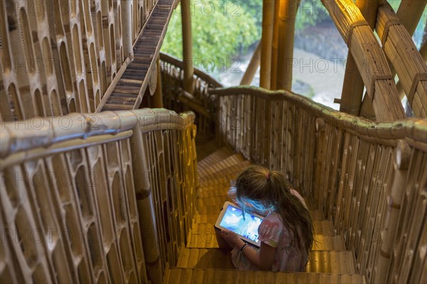 Caucasian girl using digital tablet on steps