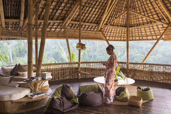 Caucasian woman on bamboo hotel patio