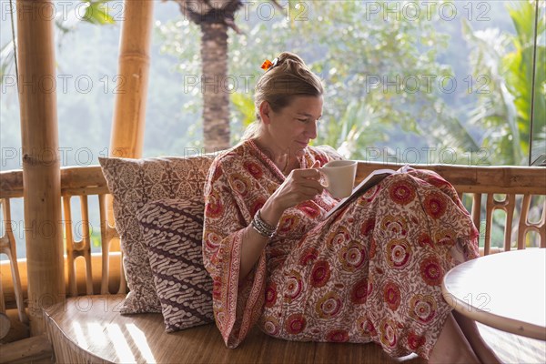 Caucasian woman drinking coffee on patio